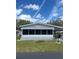 Cozy single-story home featuring a screened-in porch and well-maintained lawn at 32 Berna Cir, Winter Haven, FL 33884