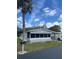 Charming single-story home with a screened-in porch and mature landscaping at 32 Berna Cir, Winter Haven, FL 33884