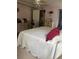 Inviting bedroom with a bed covered in a decorative white quilt and dresser at 32 Berna Cir, Winter Haven, FL 33884