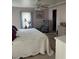 Comfortable bedroom with a bed covered in a decorative white quilt and dresser at 32 Berna Cir, Winter Haven, FL 33884