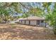 This home features a large backyard with plenty of room for outdoor activities and entertaining, framed by mature trees at 3323 Fox Ridge Dr, Winter Haven, FL 33884