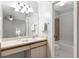 Bright bathroom featuring a vanity, tub, shower combo, and modern lighting at 3323 Fox Ridge Dr, Winter Haven, FL 33884