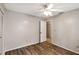 This bedroom features neutral walls, wood-look floors, and a ceiling fan with updated light fixture at 3323 Fox Ridge Dr, Winter Haven, FL 33884
