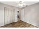 Bedroom featuring wood-look floors, ceiling fan, and closet with white doors at 3323 Fox Ridge Dr, Winter Haven, FL 33884
