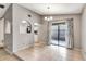 Bright dining room featuring tile floors, elegant chandelier, and sliding glass doors to the patio at 3323 Fox Ridge Dr, Winter Haven, FL 33884