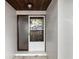 Welcoming front entrance featuring a secure screen door and textured exterior wall at 3323 Fox Ridge Dr, Winter Haven, FL 33884