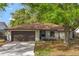 Charming single-story home featuring a two-car garage, well-maintained lawn, and mature landscaping, perfect for curb appeal at 3323 Fox Ridge Dr, Winter Haven, FL 33884