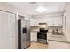 Bright kitchen with stainless steel appliances, subway tile backsplash and white cabinets at 3323 Fox Ridge Dr, Winter Haven, FL 33884