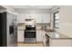 Modern kitchen featuring white cabinets, stainless steel appliances and granite countertops at 3323 Fox Ridge Dr, Winter Haven, FL 33884