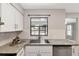 Close-up of the modern kitchen sink with stainless steel faucet and granite countertops at 3323 Fox Ridge Dr, Winter Haven, FL 33884