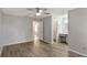 Main bedroom featuring wood-look floors, ceiling fan, and en-suite bathroom with vanity at 3323 Fox Ridge Dr, Winter Haven, FL 33884