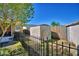 Fenced backyard with storage shed and partial view of the home's screened-in porch at 3430 Cove E Ct, Winter Haven, FL 33880