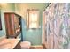 Charming bathroom with a modern vanity, toilet, and a stylish shower curtain at 3430 Cove E Ct, Winter Haven, FL 33880