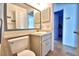 Bathroom with gray vanity, white commode and decorative mirror at 3430 Cove E Ct, Winter Haven, FL 33880