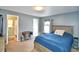 Cozy bedroom with natural light, a sewing machine table and a comfortable queen-size bed at 3430 Cove E Ct, Winter Haven, FL 33880