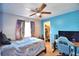 Bedroom with ceiling fan, window with colorful curtains, and an open closet at 3430 Cove E Ct, Winter Haven, FL 33880