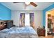 Bedroom with ceiling fan, window with colorful curtains, and an open closet at 3430 Cove E Ct, Winter Haven, FL 33880