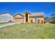 Charming single Gathering home showcasing a well-maintained front lawn and attached two-car garage at 3430 Cove E Ct, Winter Haven, FL 33880