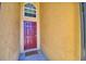 Charming front entry showcases a red door, a decorative window, and a welcoming 'Dogs Welcome' door mat at 3430 Cove E Ct, Winter Haven, FL 33880