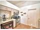 Efficient kitchen featuring stainless steel appliances, granite countertops, and tile backsplash at 3430 Cove E Ct, Winter Haven, FL 33880
