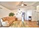 Living room showcasing vaulted ceilings, wood-look tile flooring, neutral paint, and a comfortable sectional couch at 3430 Cove E Ct, Winter Haven, FL 33880