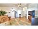Open living room featuring vaulted ceilings, wood-look tile flooring, neutral paint, and comfortable seating at 3430 Cove E Ct, Winter Haven, FL 33880