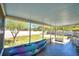 Relaxing screened patio with tiled floor, garden view, and outdoor seating, perfect for enjoying the outdoors at 3430 Cove E Ct, Winter Haven, FL 33880