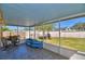 Relaxing screened patio with tiled floor, garden view, and outdoor seating, perfect for enjoying the outdoors at 3430 Cove E Ct, Winter Haven, FL 33880