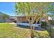 Backyard view of the screened-in porch featuring an exterior patio, a spacious backyard, and mature trees at 3430 Cove E Ct, Winter Haven, FL 33880
