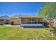 Backyard view of a screened in porch and patio of the home, with a partial view of the yard at 3430 Cove E Ct, Winter Haven, FL 33880