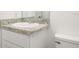 Bathroom with granite counters, white cabinets and commode at 3438 Avenue E Nw, Winter Haven, FL 33880