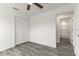 Bedroom with wood-look floors, ceiling fan and closet, leading to bath at 3438 Avenue E Nw, Winter Haven, FL 33880