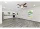 Inviting living space showcasing modern flooring, recessed lights, and a seamless flow into the kitchen at 3438 Avenue E Nw, Winter Haven, FL 33880