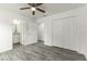 Main bedroom with wood-look floors, ceiling fan and ensuite bathroom at 3438 Avenue E Nw, Winter Haven, FL 33880