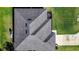 High angle view of a modern roof with skylights complemented by a pristine lawn and concrete driveway at 3467 Sutton Ridge St, Lakeland, FL 33810