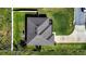Aerial view of a home featuring a well-maintained roof, lush green lawn, and an extended driveway at 3467 Sutton Ridge St, Lakeland, FL 33810