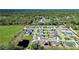 A bird's eye view shows this home in a neighborhood surrounded by green spaces and forest at 3467 Sutton Ridge St, Lakeland, FL 33810