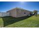 A shot of the back of the home shows sliding glass doors and outdoor cooking on the patio at 3467 Sutton Ridge St, Lakeland, FL 33810