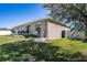 Backyard with a well-maintained lawn, privacy fence, and shaded patio area for outdoor enjoyment at 3467 Sutton Ridge St, Lakeland, FL 33810
