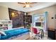 Comfortable bedroom with a bed, desk, and shelving units with ample storage space at 3467 Sutton Ridge St, Lakeland, FL 33810