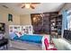 bedroom features fun decor, a trundle bed, and unique bookshelf headboard at 3467 Sutton Ridge St, Lakeland, FL 33810