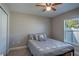 Cozy bedroom featuring neutral walls, carpet flooring, ceiling fan and a comfortable bed at 3467 Sutton Ridge St, Lakeland, FL 33810