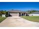 Attractive single-level home with a spacious driveway, attached garage, and a welcoming front porch at 3467 Sutton Ridge St, Lakeland, FL 33810