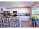 Bright kitchen features granite countertops, stainless appliances, and a cozy breakfast bar area at 3467 Sutton Ridge St, Lakeland, FL 33810