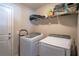 Bright laundry room with modern washer and dryer units and wire shelving for storage at 3467 Sutton Ridge St, Lakeland, FL 33810