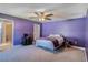 Serene main bedroom features plush carpet, a ceiling fan, and access to an ensuite bathroom at 3467 Sutton Ridge St, Lakeland, FL 33810