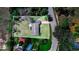 An aerial view reveals the property's spacious layout, including the house, lawn, and proximity to the road and pool area at 352 W Graham Park Dr, Haines City, FL 33844