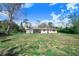 View of the back of the house with a large backyard at 352 W Graham Park Dr, Haines City, FL 33844