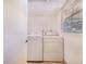 A small laundry room includes both a washer and dryer at 352 W Graham Park Dr, Haines City, FL 33844