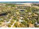 Expansive aerial showing the property surrounded by dense trees and nearby lake, offering a serene environment at 3614 Twisted Oak Ct, Lake Wales, FL 33898